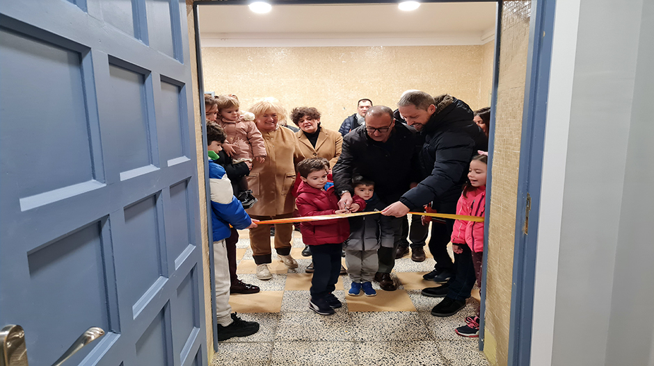 Felipe Faci, rodeado de los más pequeños de la localidad, durante el corte de cinta de la escuela infantil de Cartuja de Monegros.